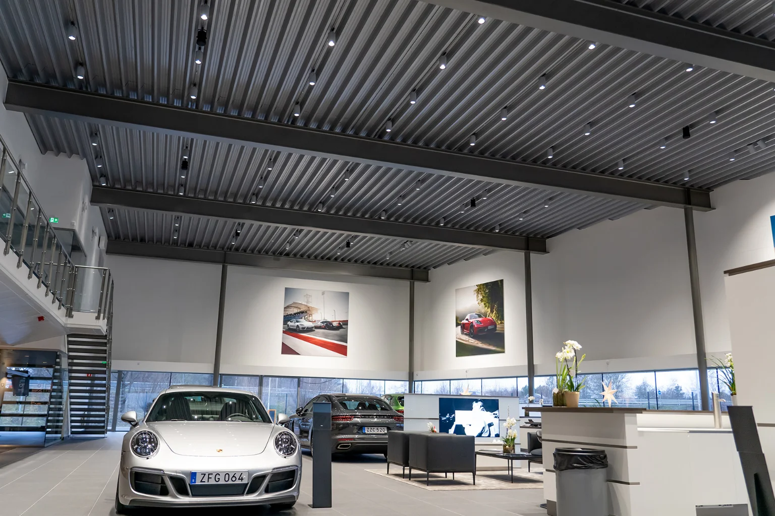 Audio Pro SP-3 mounted in lighting tracks in a car dealership