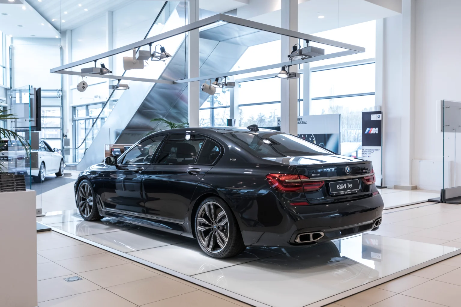Track mounted Audio Pro SP-3 speaker in a car dealership showroom